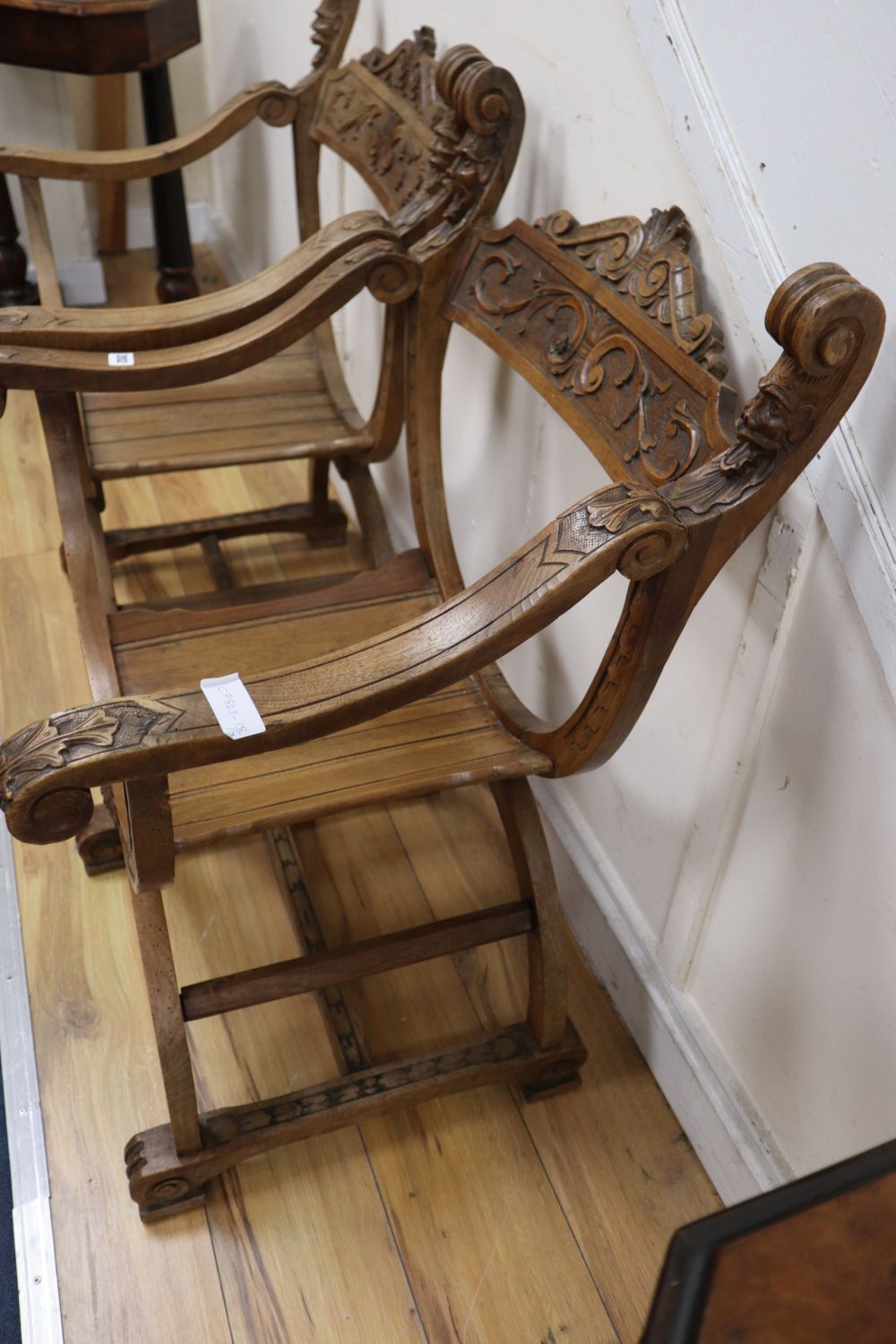 A pair of Italian carved walnut Savonarola type armchairs